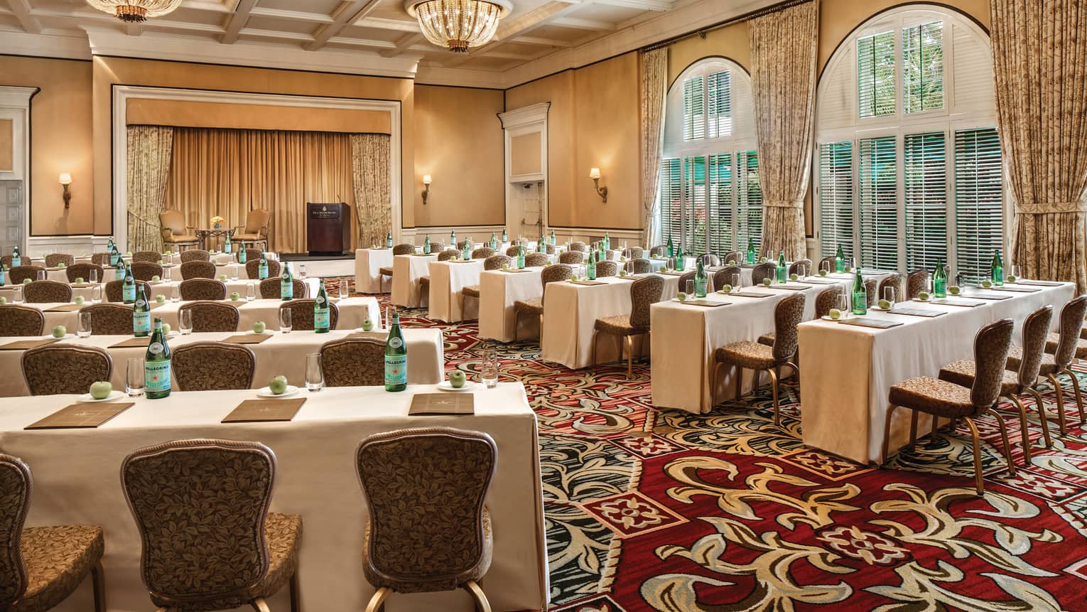 Loggia Ballroom rows of small meeting tables and chairs facing stage
