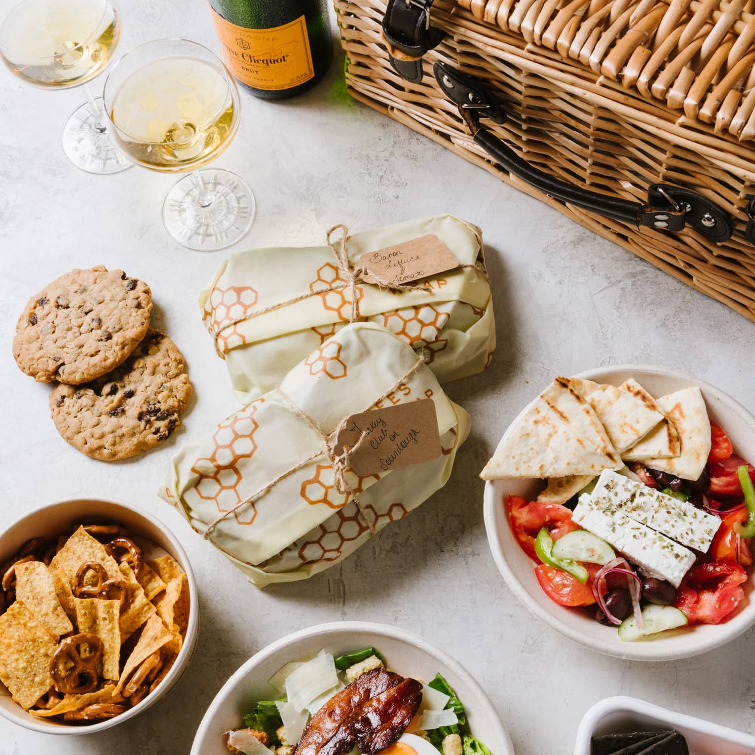 An assortment of food including salad, cookies and bread.