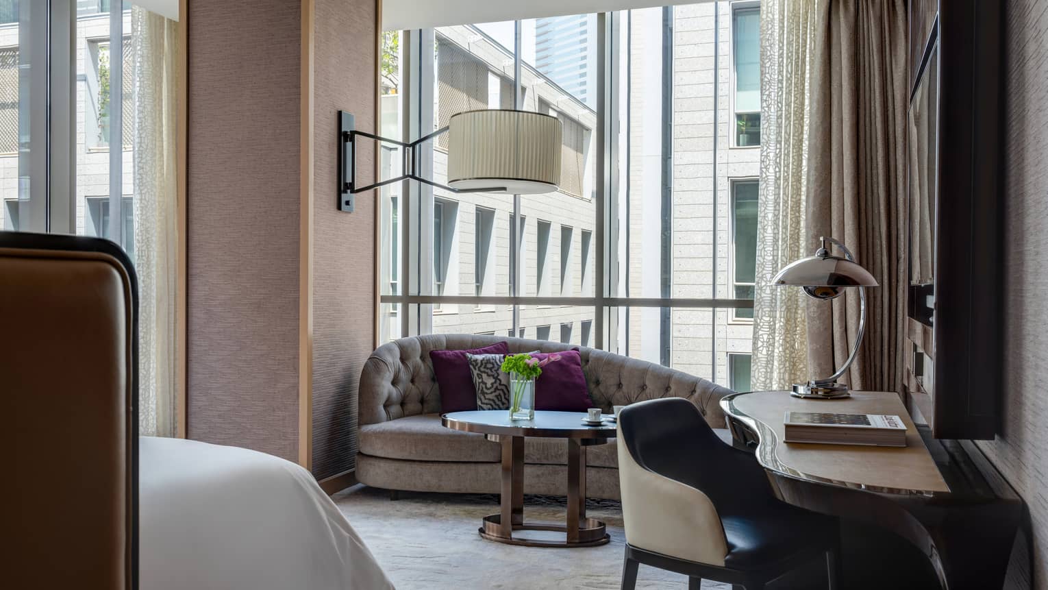 Bedroom with wall of windows, chaise and desk area