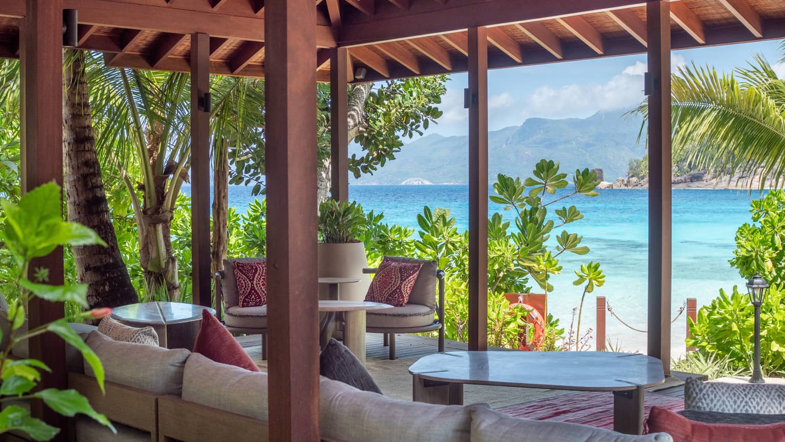 Lounge area set underneath a pavilion and looking out to tropical sea view