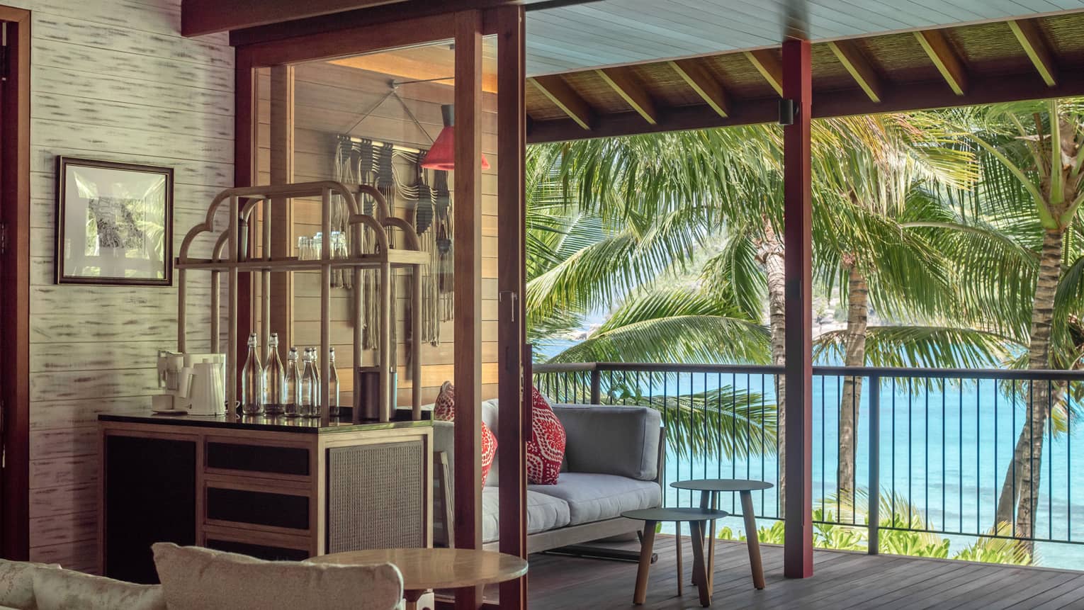 Private terrace of a bedroom, with a sofa and tropical sea views