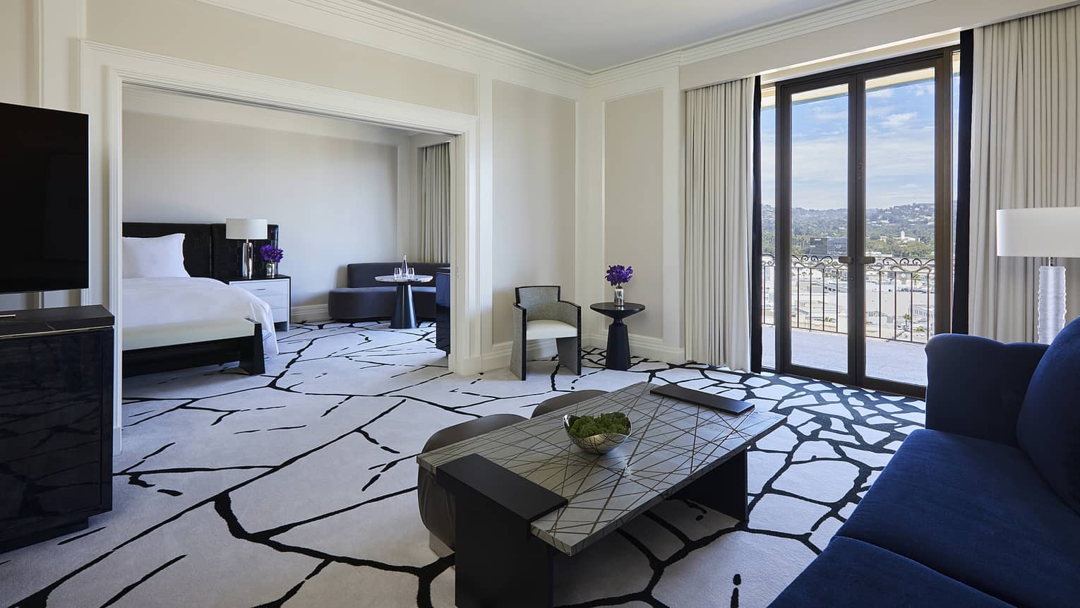 Hotel suite living room opening to bedroom