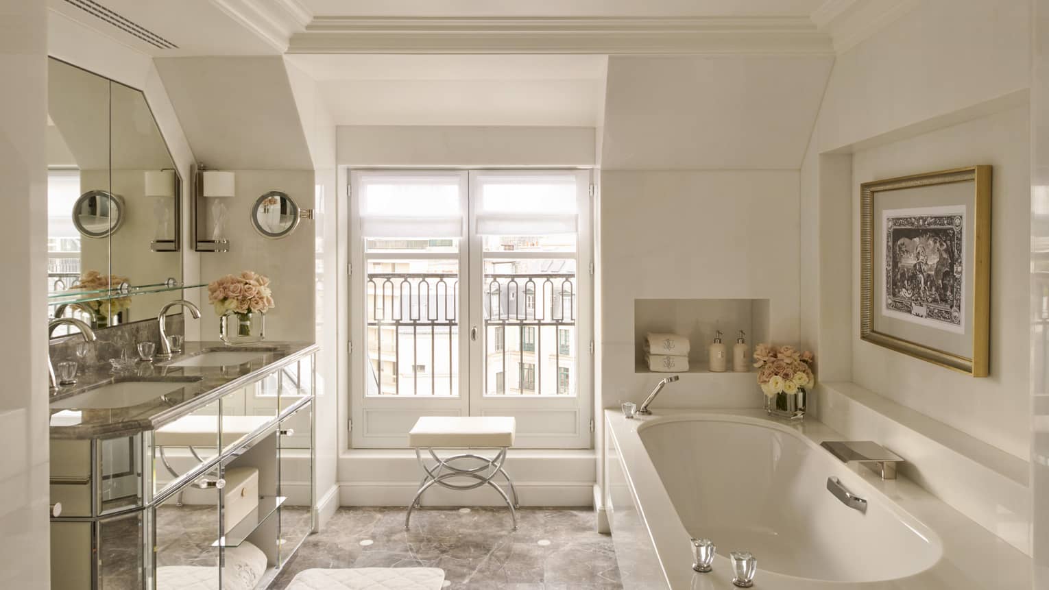 Elegant bathroom with tub, mirrored vanity and window