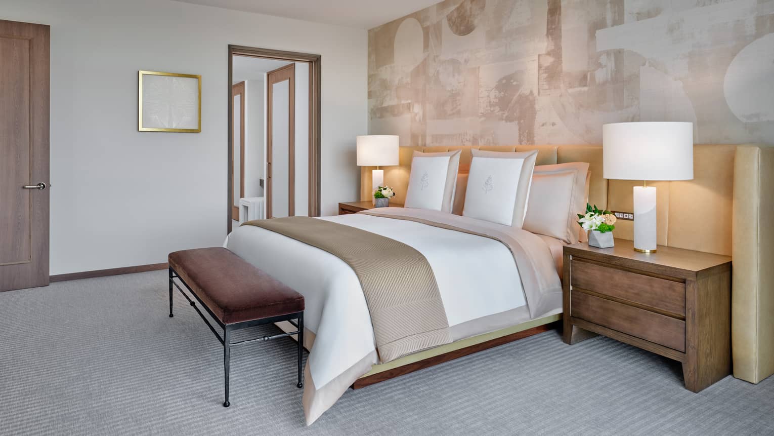 Bedroom with king bed, accent wall, bedside tables and lamps