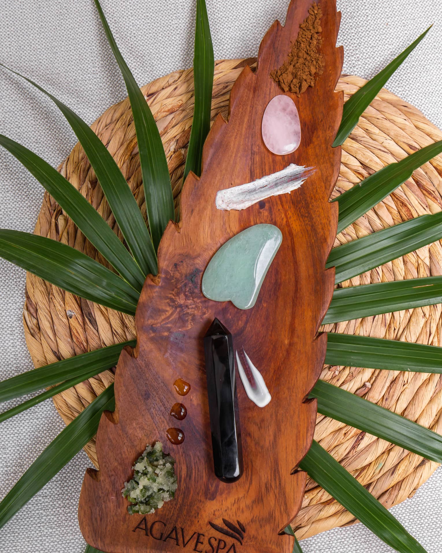 AgaveSpa arrowhead-shaped wooden tray with gemstones and treatment oils