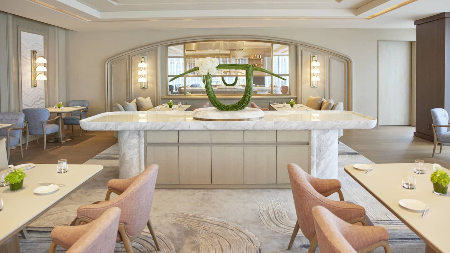 Four Seasons dining area with a marble counter and a modern floral arrangement in a light, stylish interior