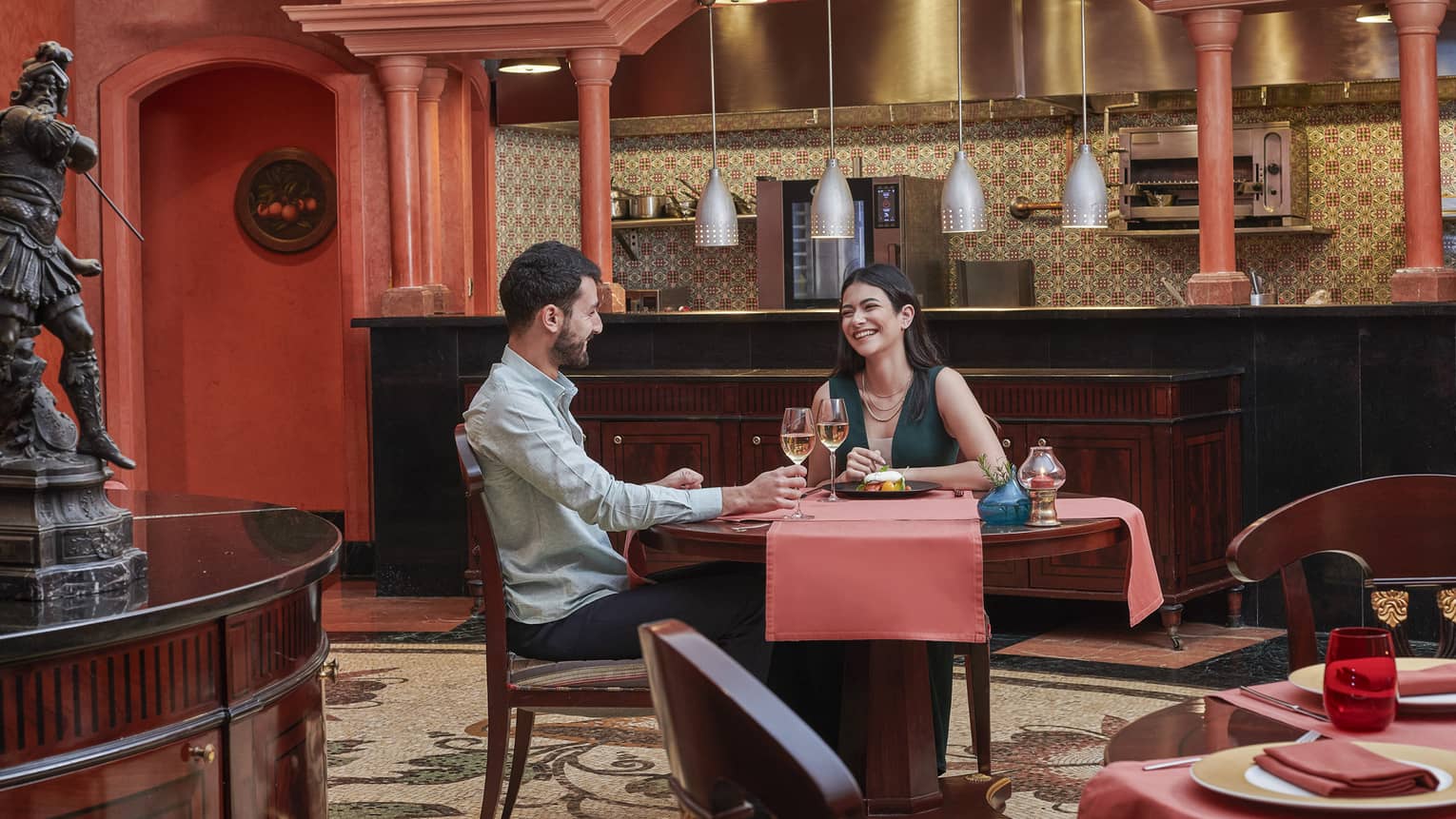 Couple enjoys a glass of wine at Stefano's, red accents