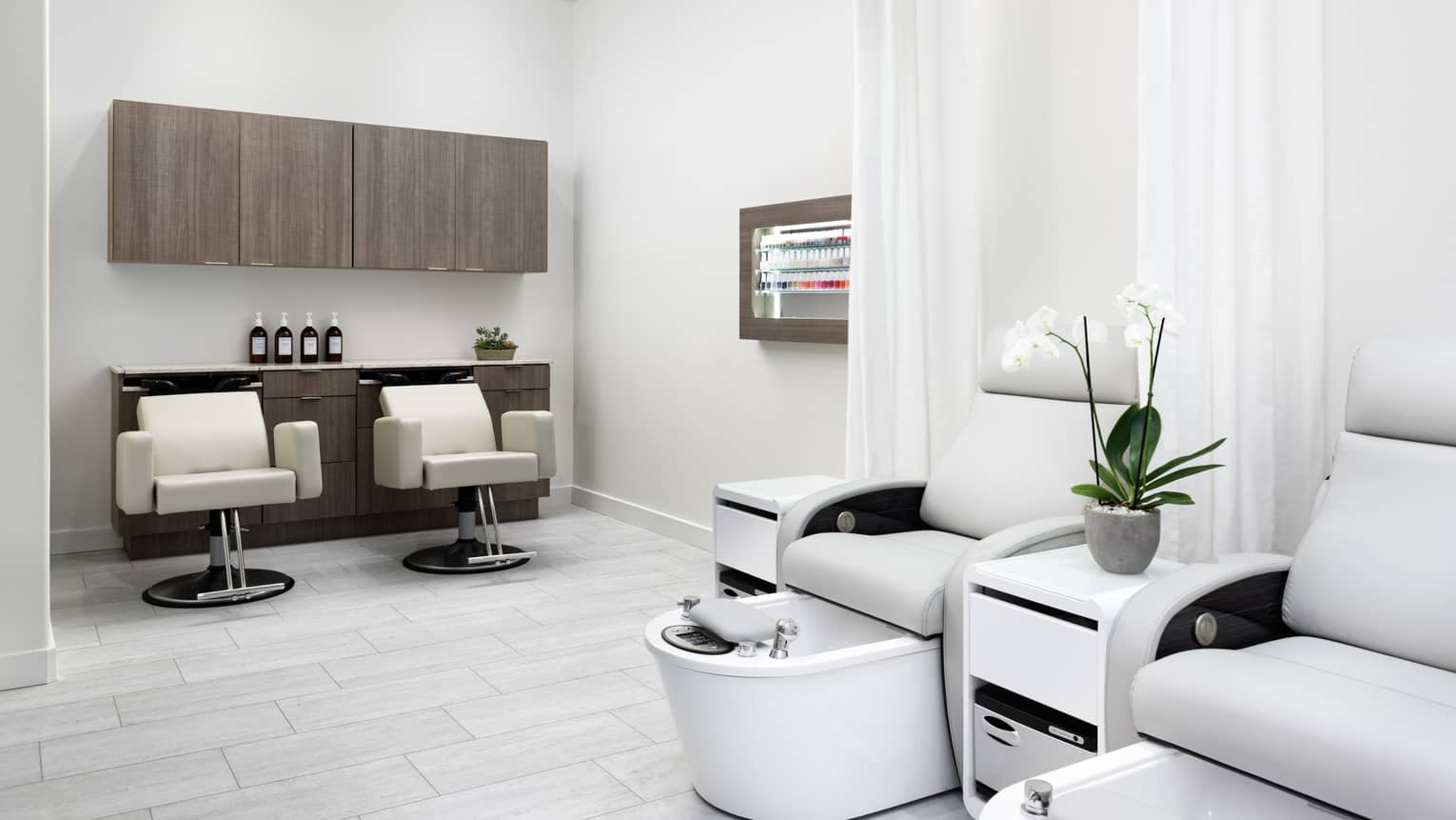 A brightly lit salon with large comfortable chairs.