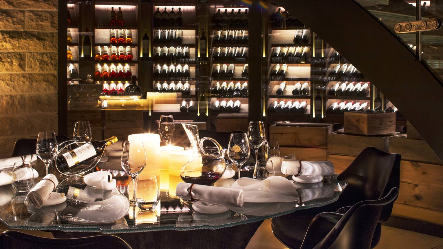 Wine Cellar dining table with bottles of wine, glasses, large candles