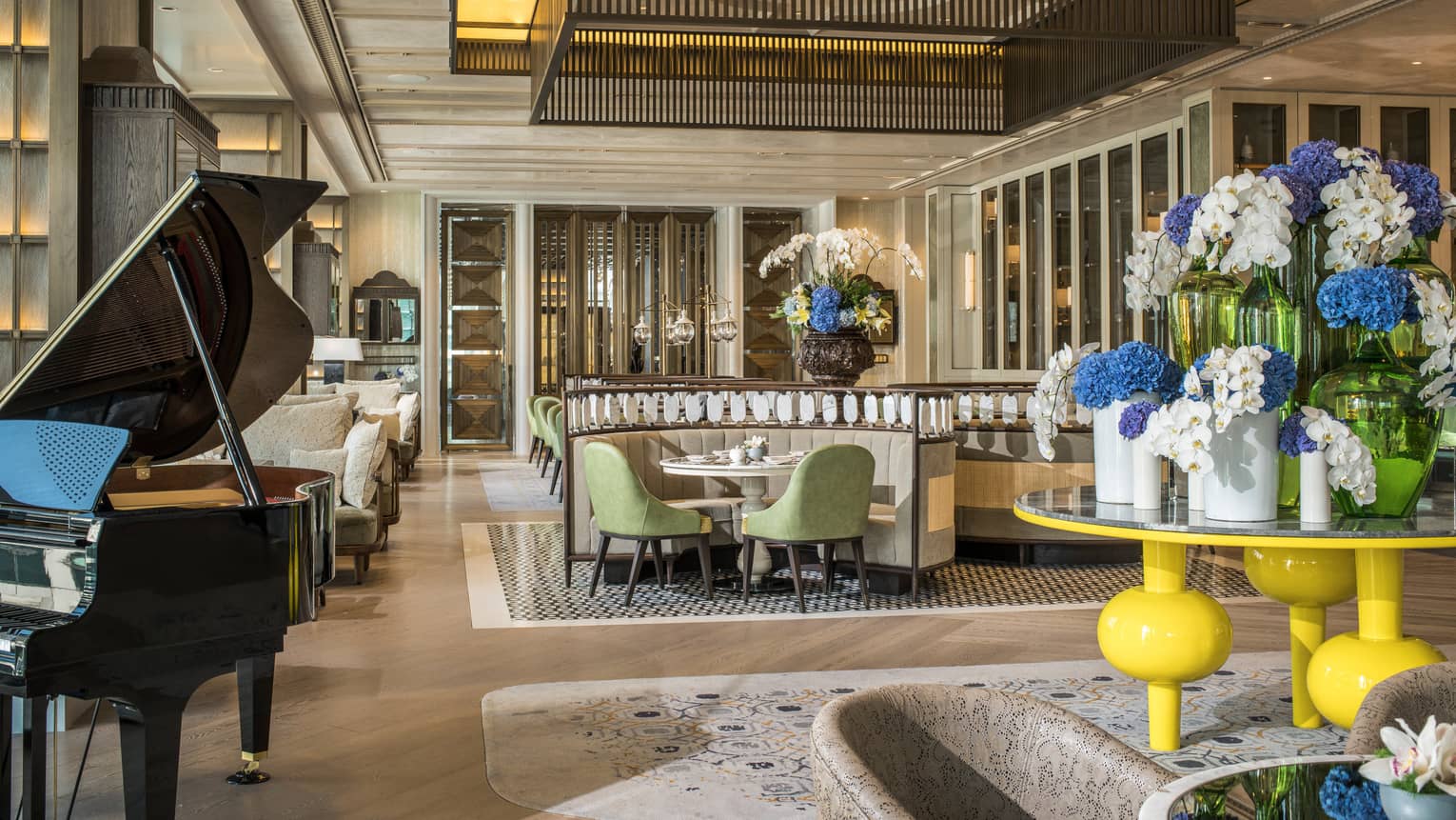 Lobby Lounge seating area with piano and floral arrangement