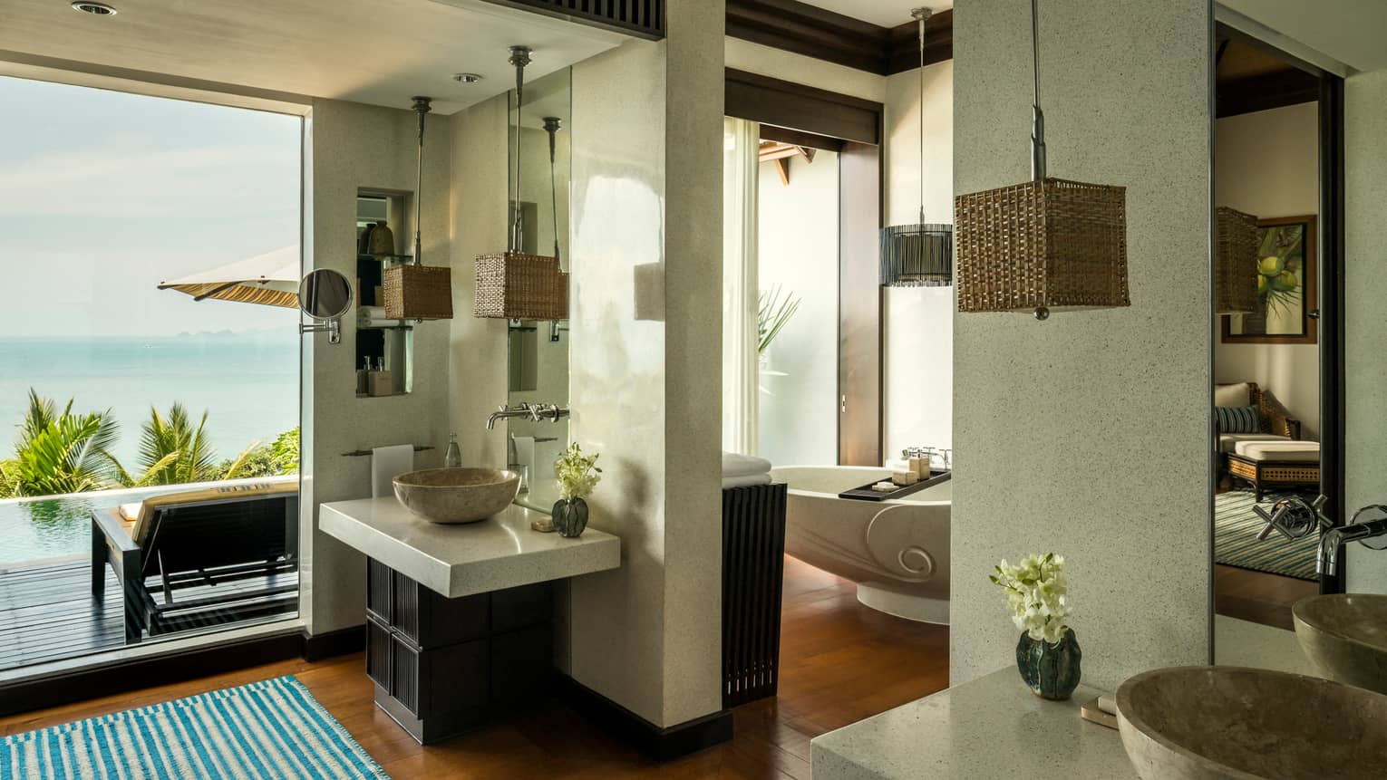 Villa bathroom with double marble sinks, freestanding tub, floor-to-ceiling window