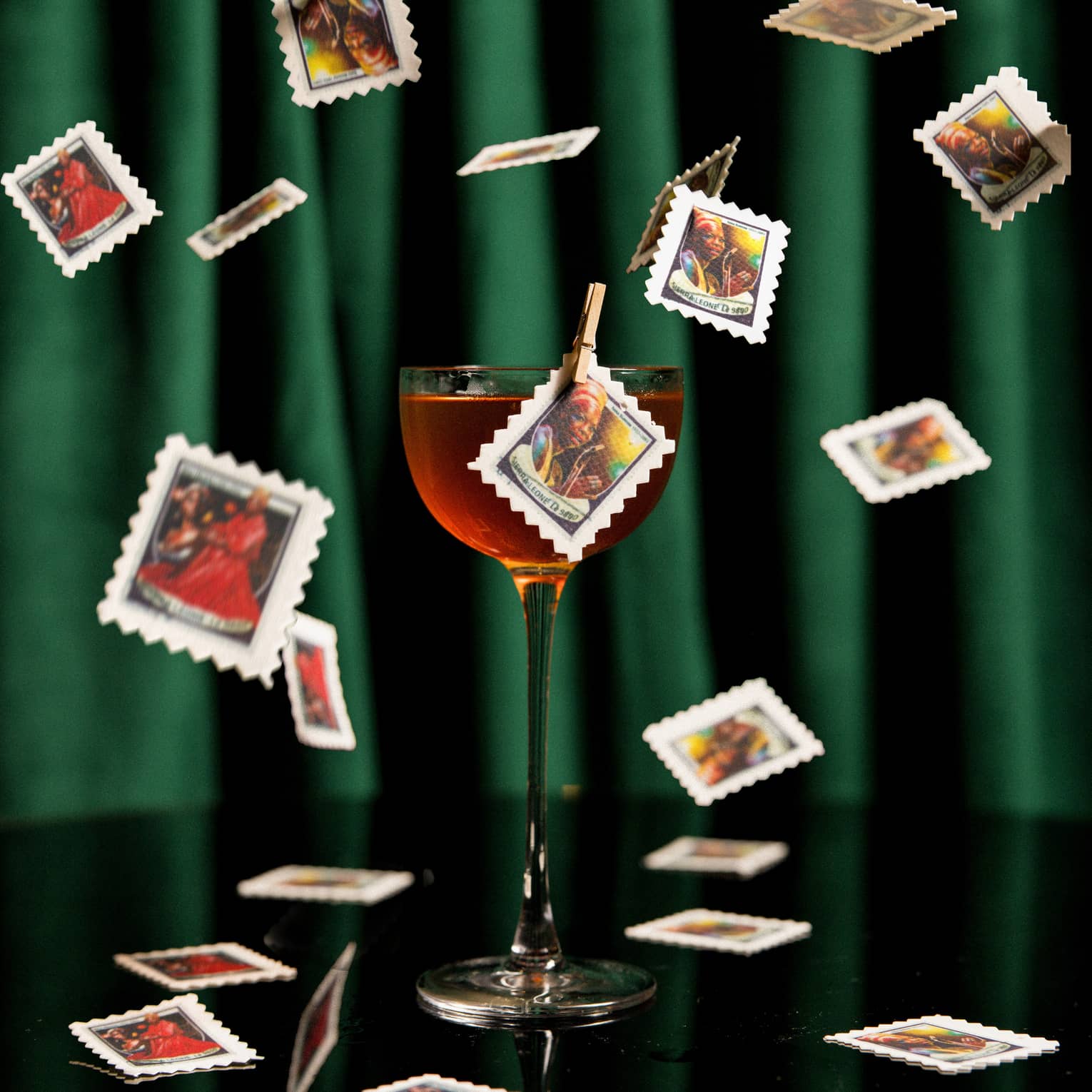 A glass of wine with cards falling around it