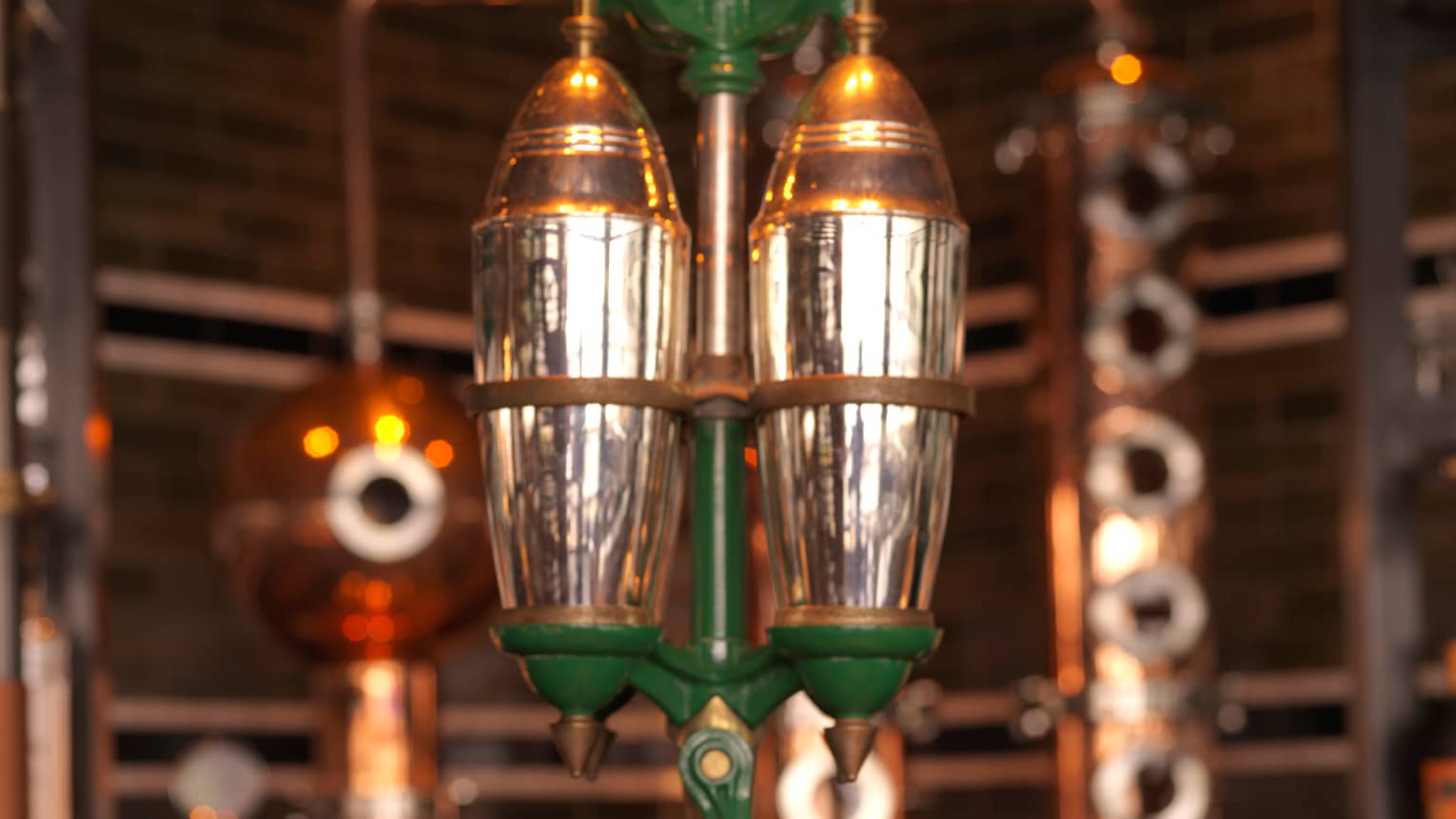 Close-up of copper, silver and green rare 5-foot-tall, hand-operated cocktail shaker at Butcher & Still