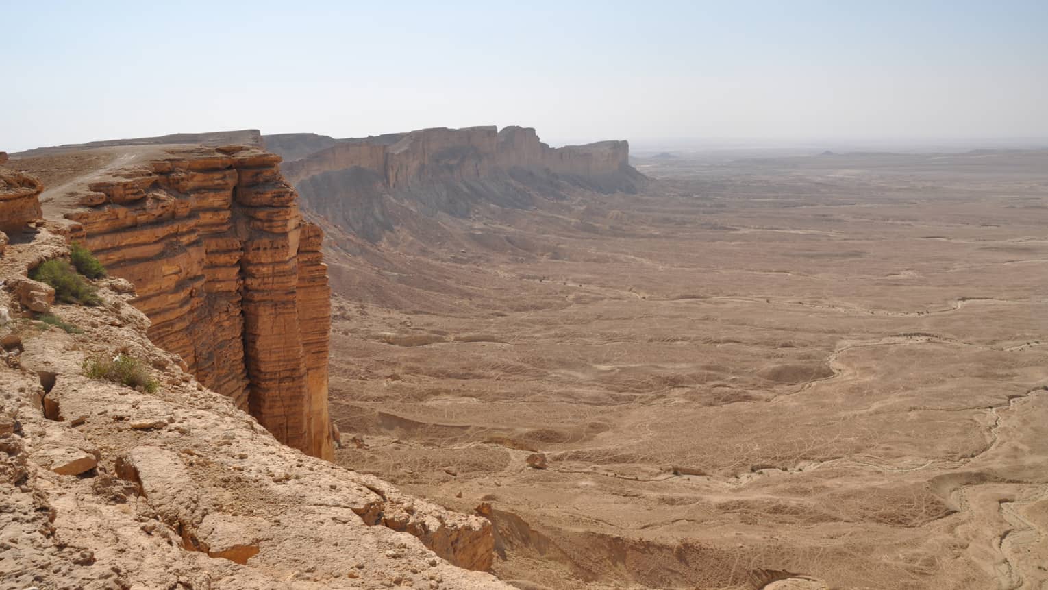 A rocky cliff overlooking a canyon 
