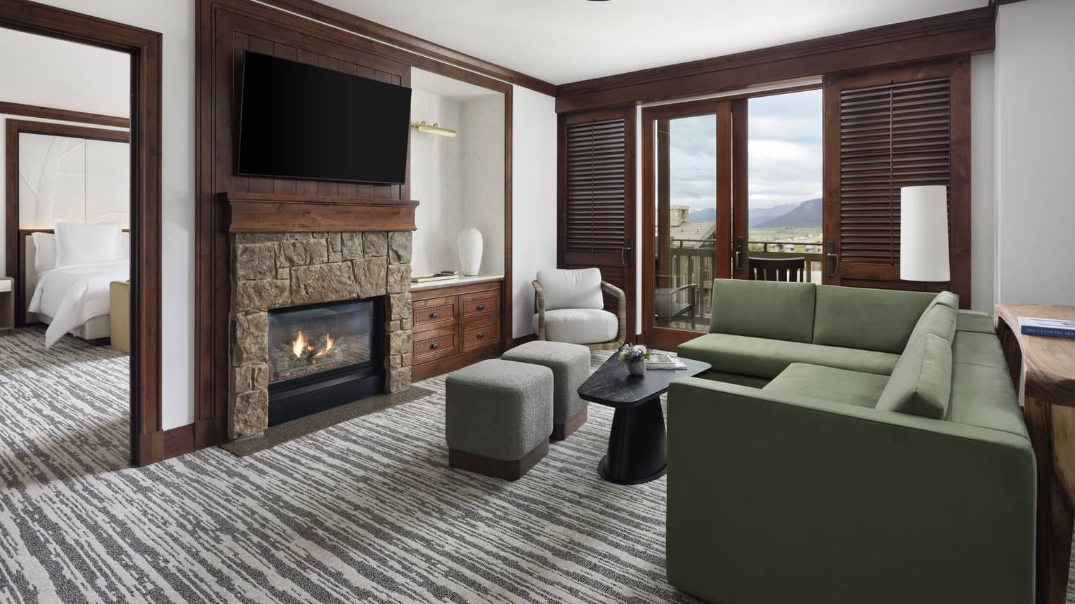 Living room with green sectional sofa, fireplace and TV
