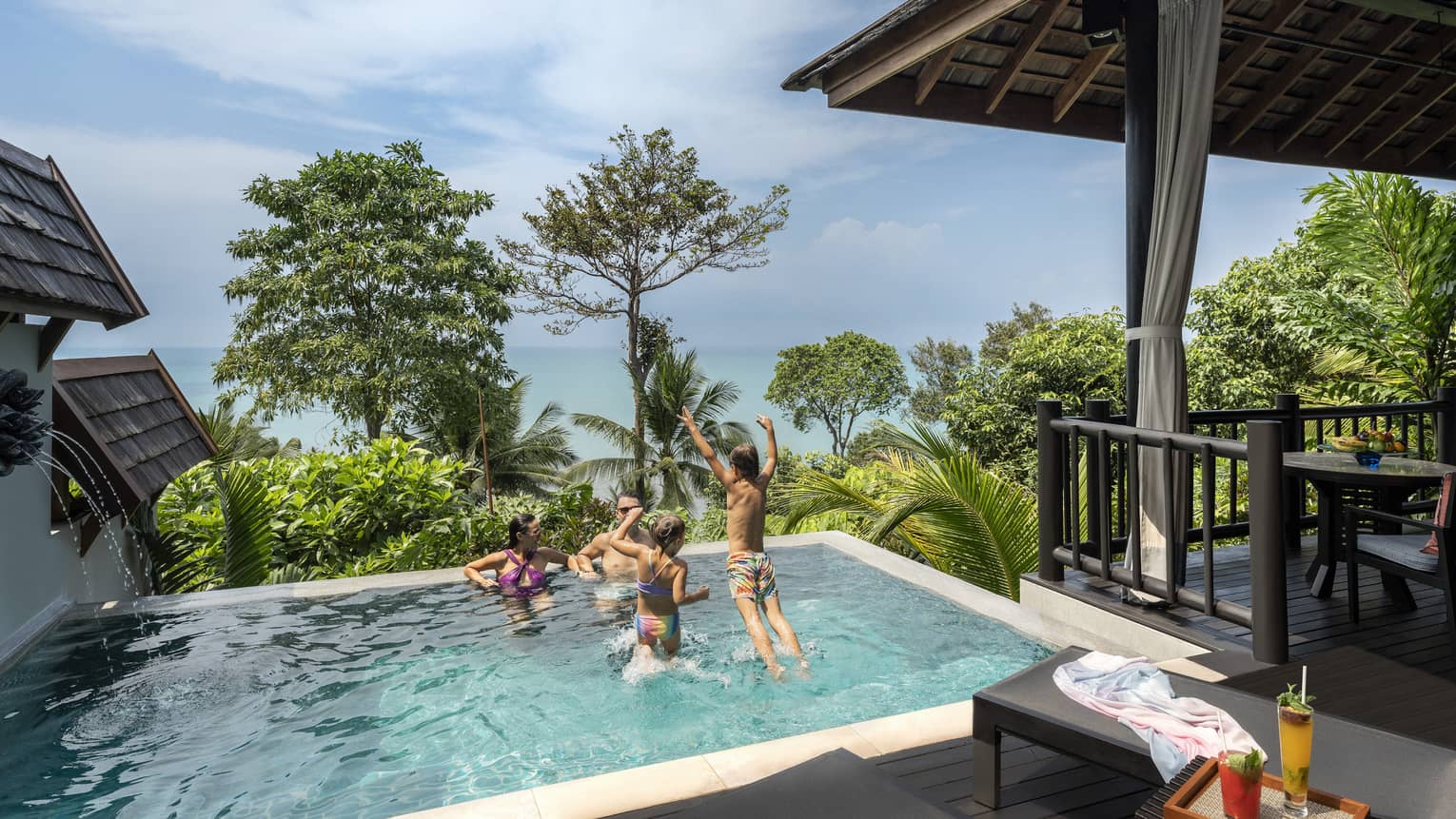 Family of four play in small pool of private pool