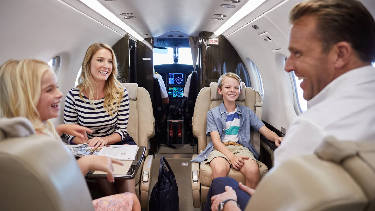 Family aboard a private Lanai Air luxury plane on the way to the Resort
