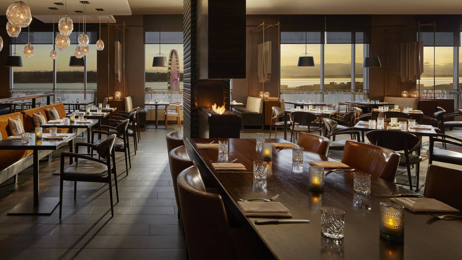 A dimly lit restaurant with large windows.