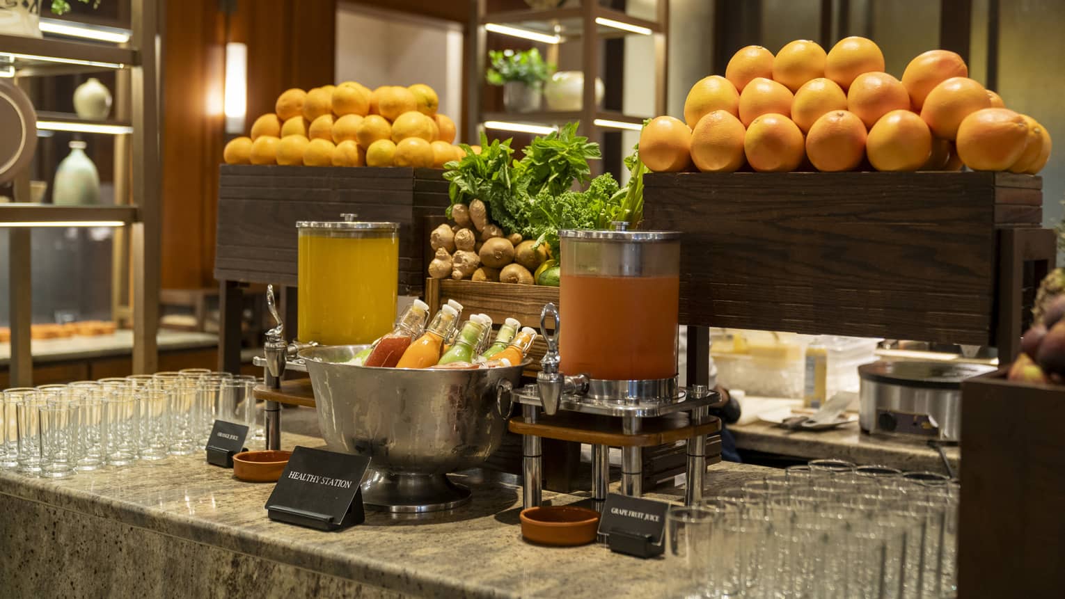 Brunch display of stacked grapefruit and assorted juices and glassware