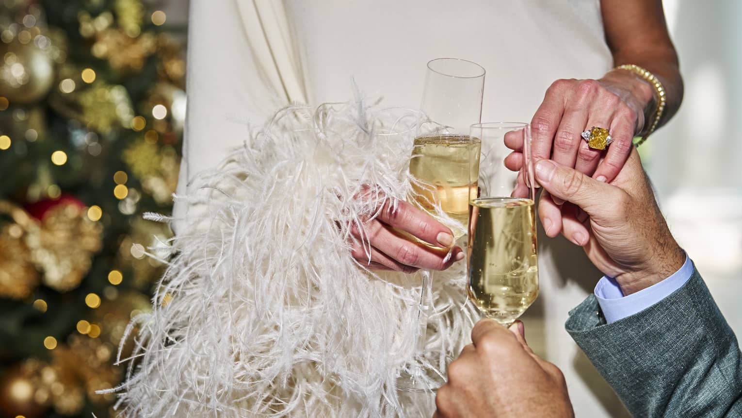 Two people holding glasses of champagne.