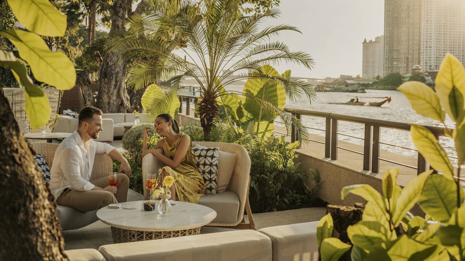 Man and woman enjoying a drink in the outdoor lounge