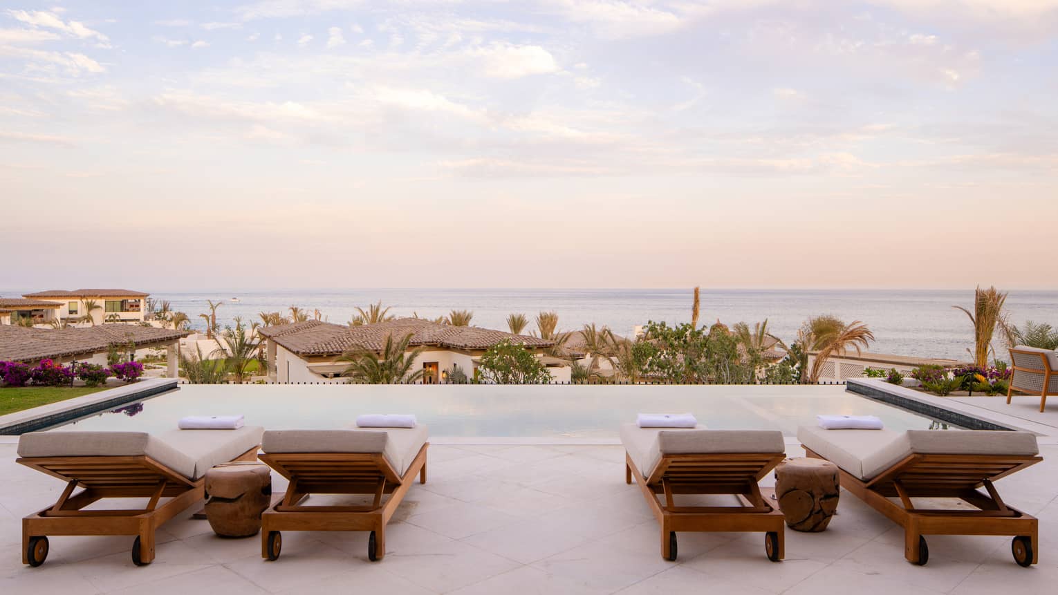 Ocean-view villa pool terrace with four sun loungers at Four Seasons Resort Cabo San Lucas at Cabo Del Sol