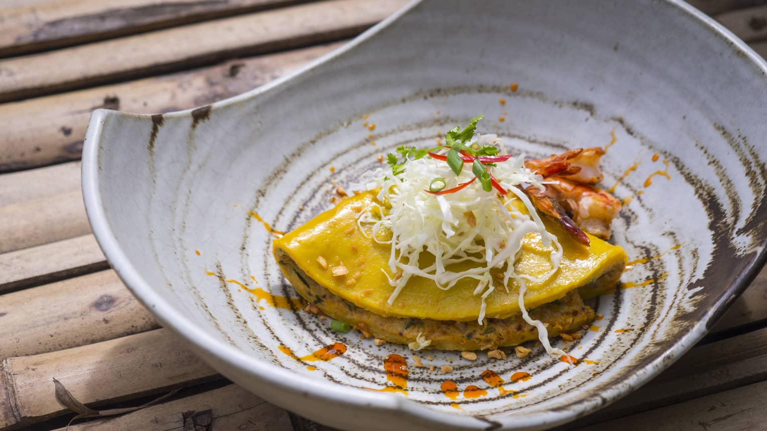 Asian dish with garnish served in pottery bowl 