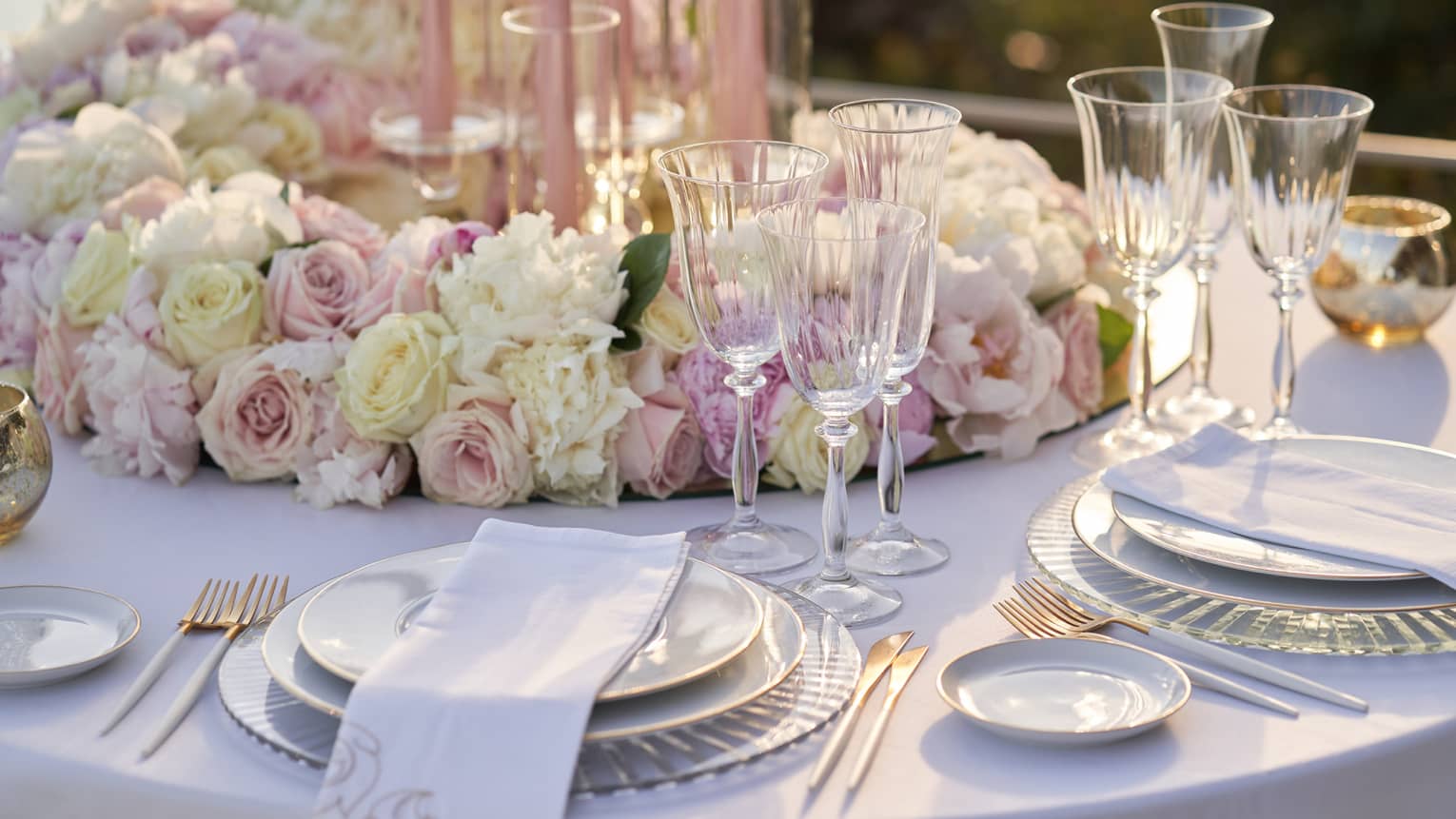 Elegant wedding table place setting with white and pink roses at Club Dauphin