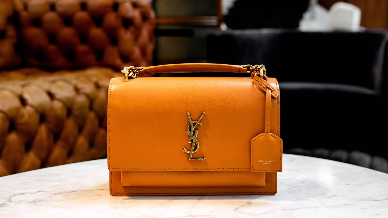 A luxury handbag on a white table.