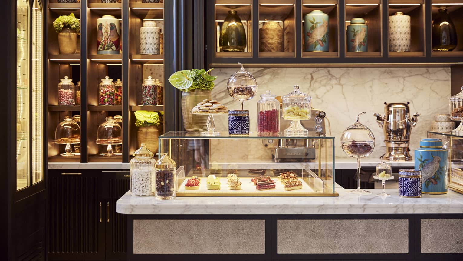 A pastry shop with pastries in a glass case.