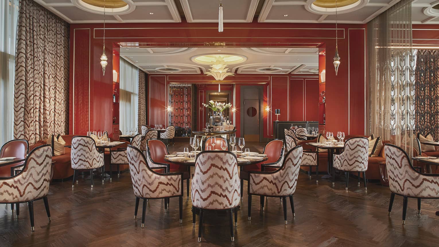 Alto restaurant dining room, each round table has four arm chairs, stylish geometric paterns