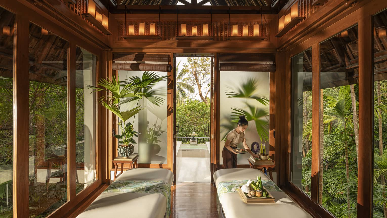 Spa team member prepares couples treatment room