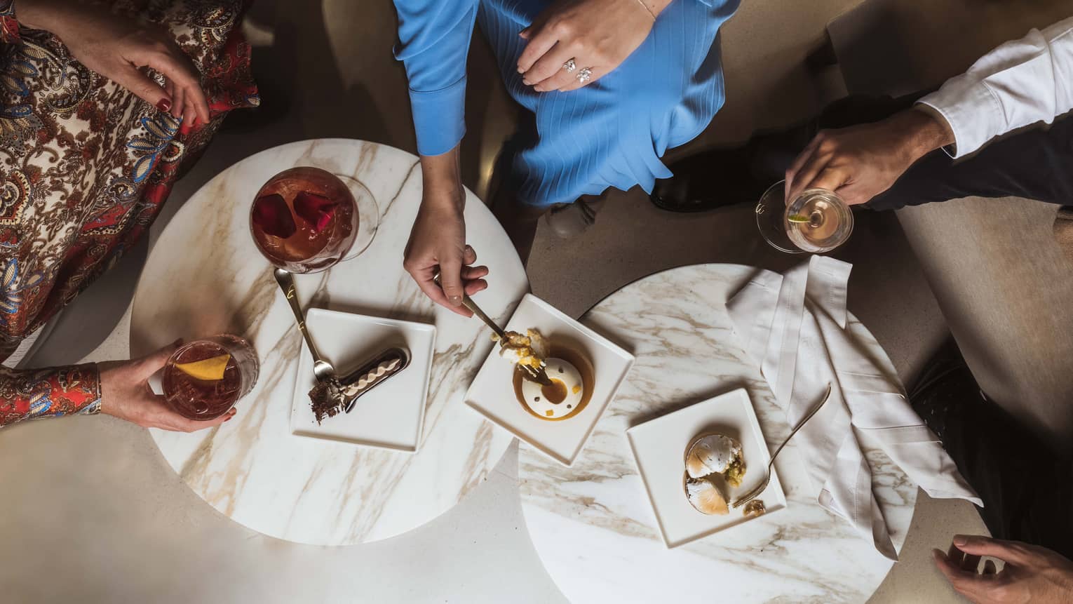 Aerial shot of guests enjoying cocktails and dessert