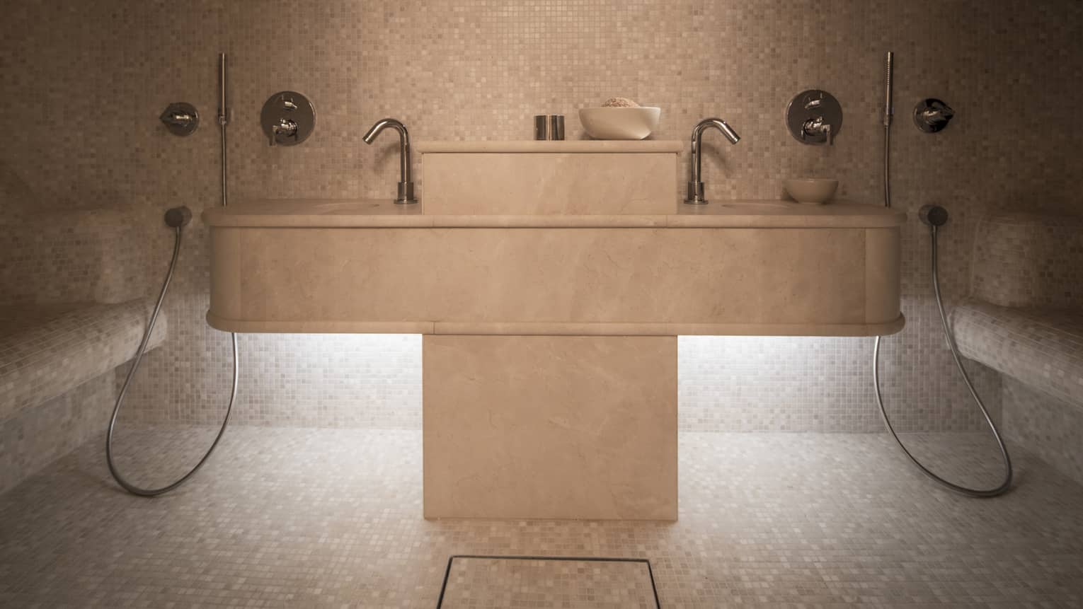 Steam room with tiled walls, floors and benches, and chrome fixtures