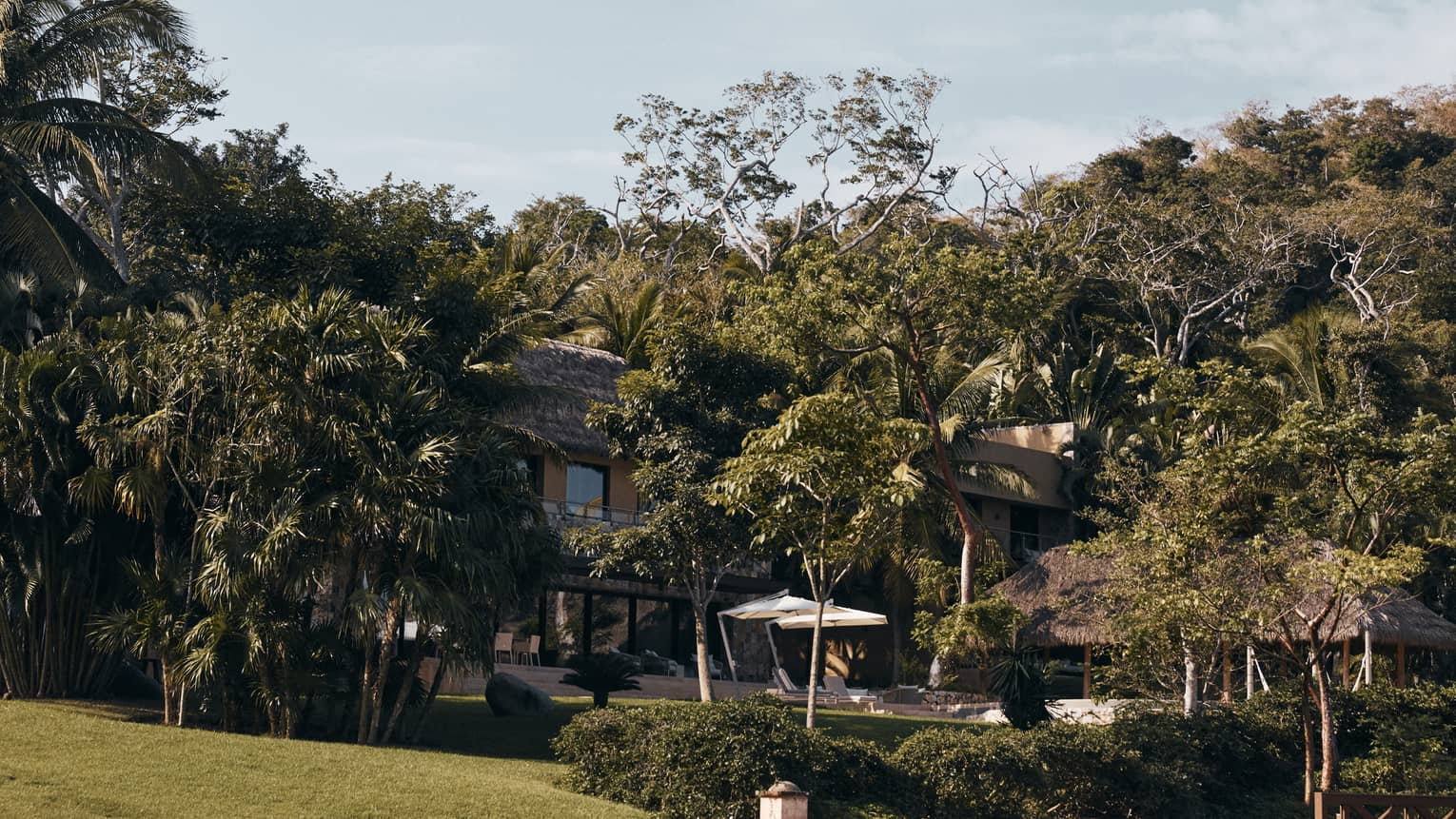 Exterior of Casa Vista six-bedroom residence at Four Seasons Resort Tamarindo, surrounded by lush tropical foliage