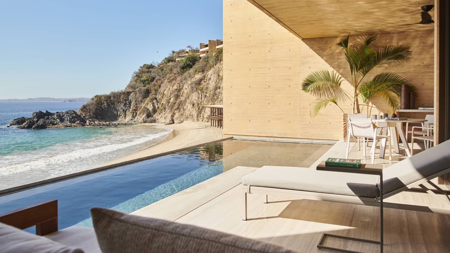 The exterior of a suite with a small pool next to the ocean.