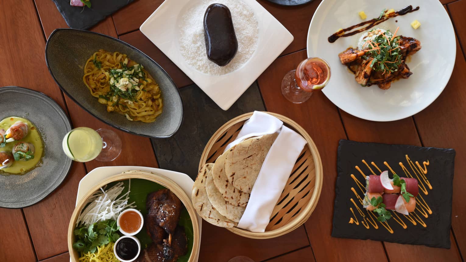 Aerial view of Aramara five-spiced half duck with chopped cilantro, coleslaw and grilled tortilla in baskets