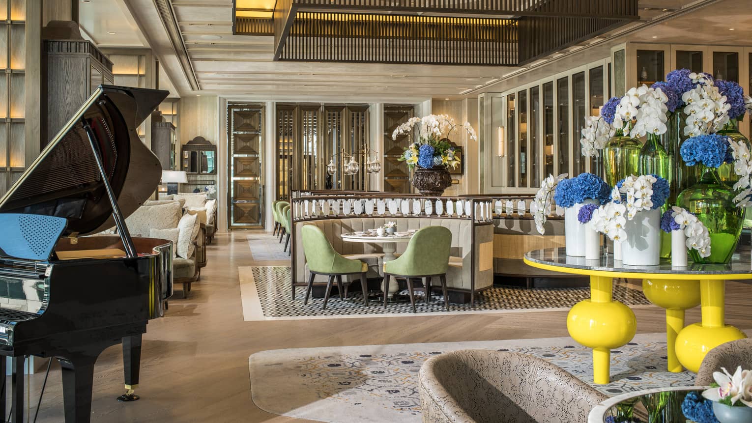 Lobby Lounge seating area with piano and floral arrangement