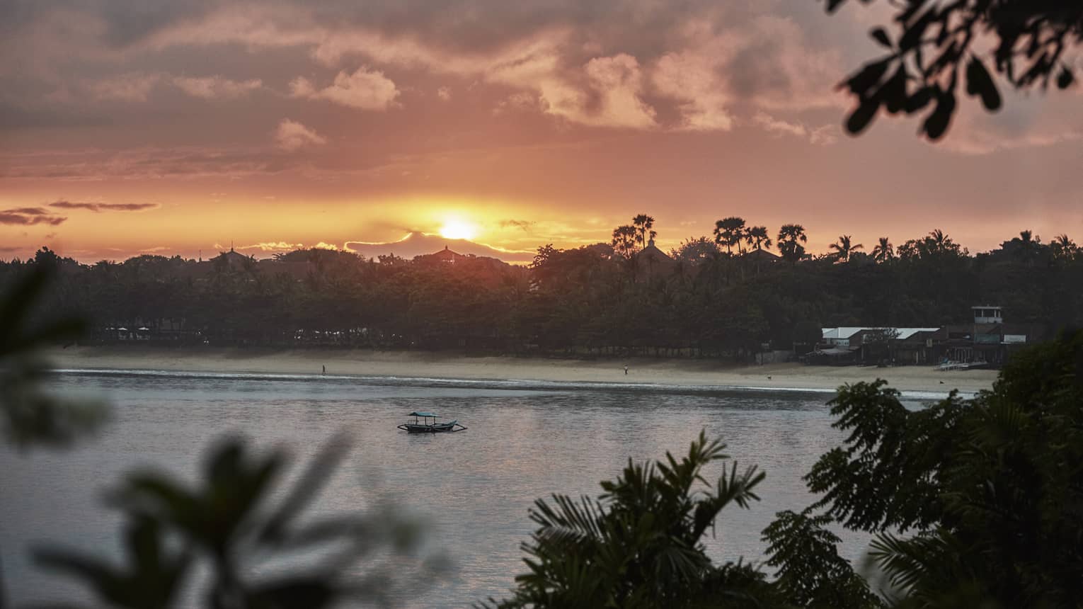 Sunrise over trees and water, small boat 