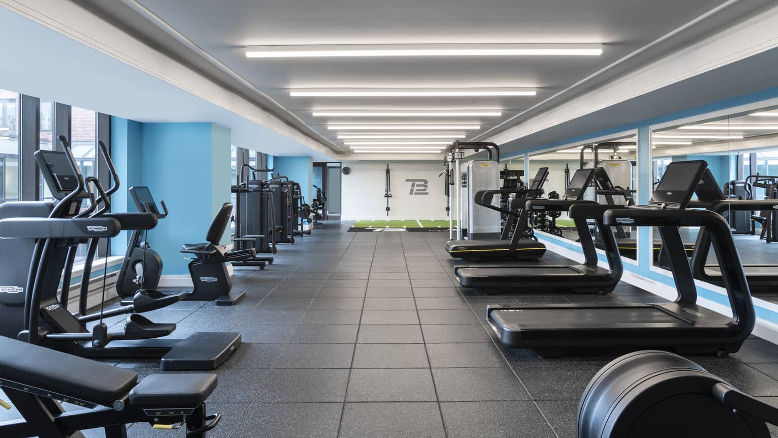 An indoor gym with cardio equipment.