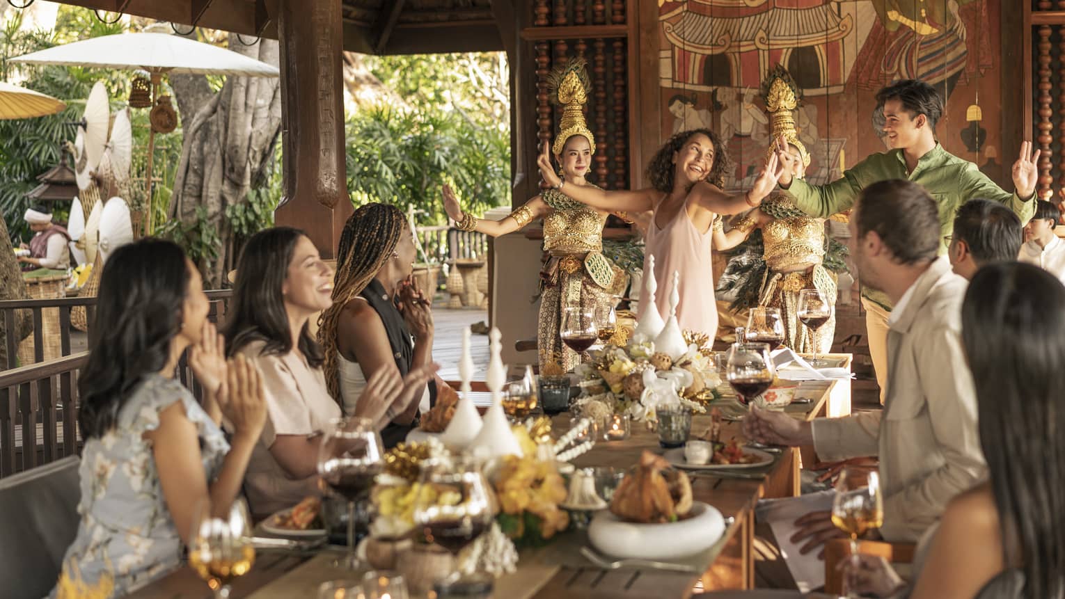 Friends gather at Rim Tai Kitchen for a group dinner with traditional Thai dancers