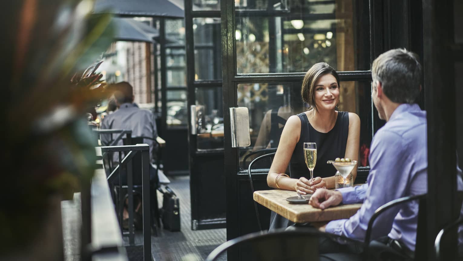 Couple dine on urban restaurant patio