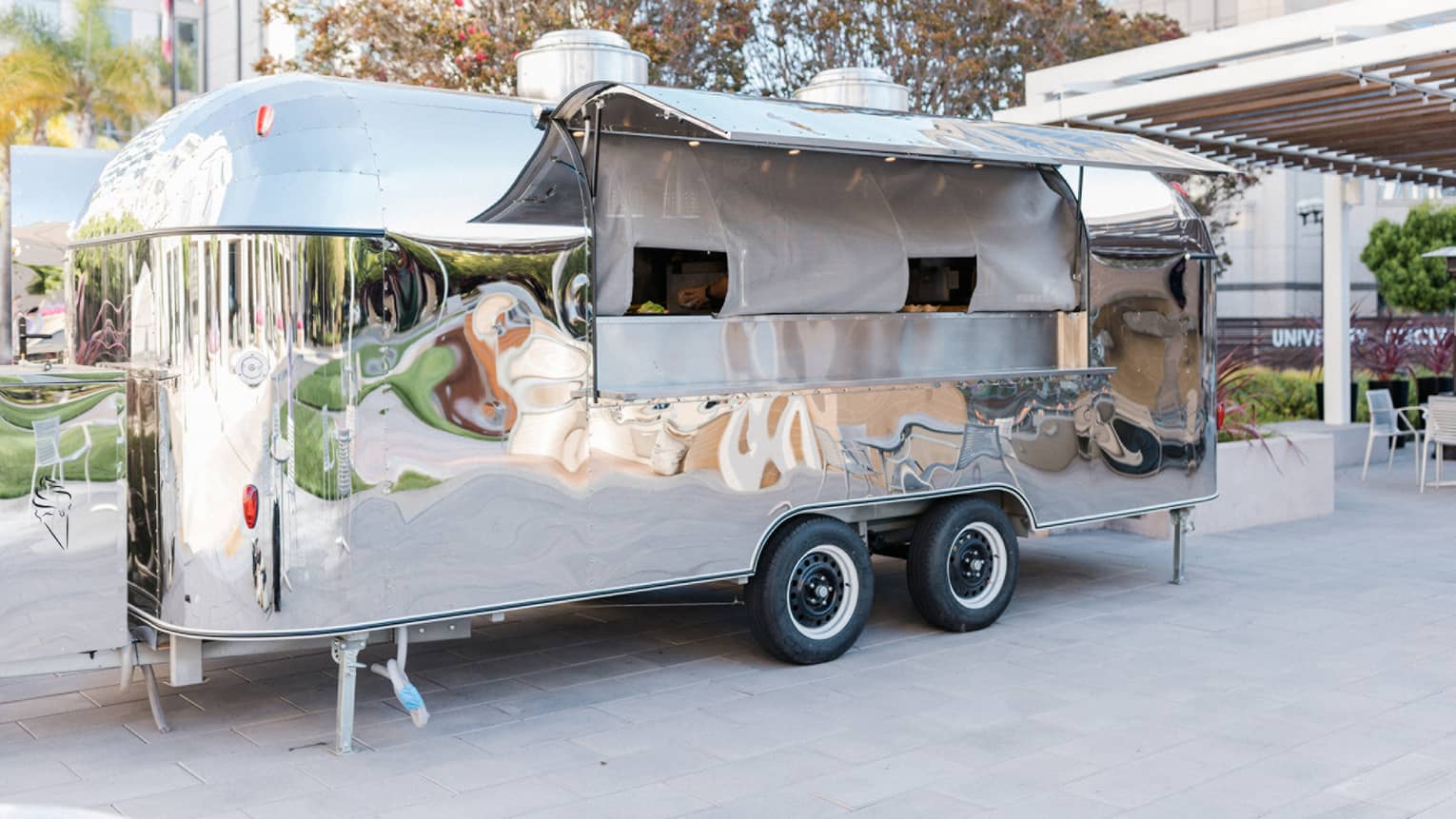 A food truck outside a large building.