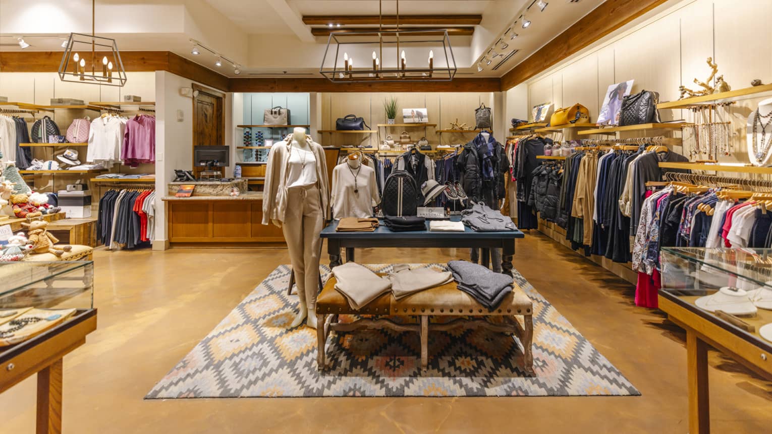 Clothing boutique with clothing items and jewelry on display.