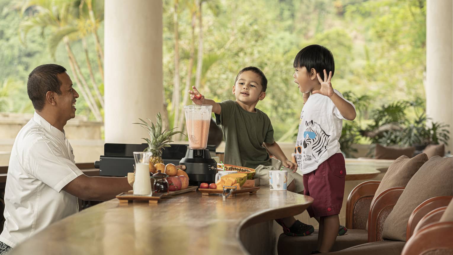 Two young boys make Jati Bar milkshakes with bartender