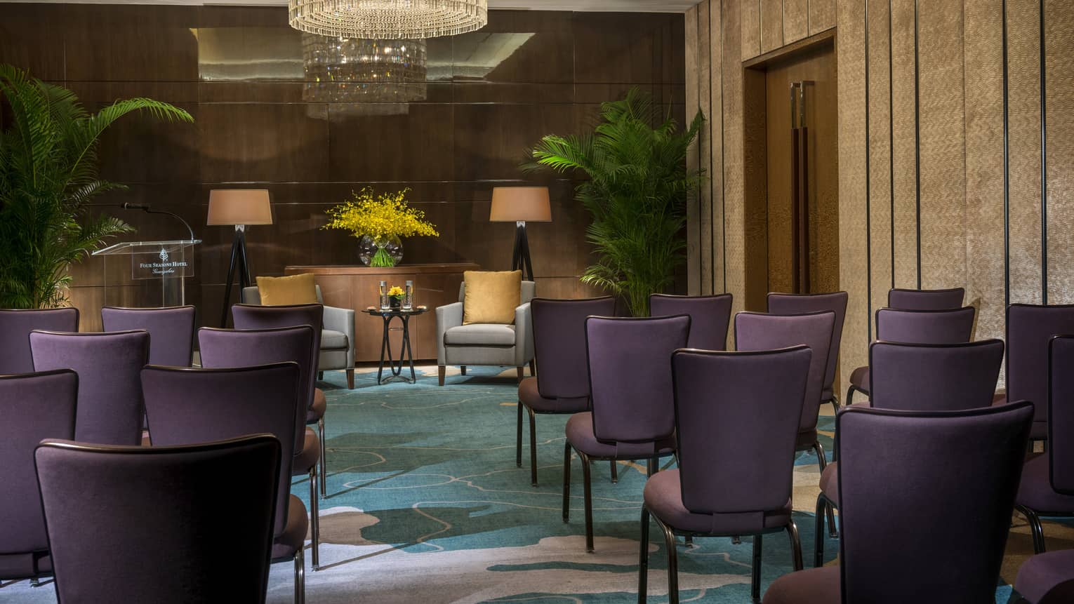 Sapphire Meeting Room conference, rows of purple chairs facing two armchairs