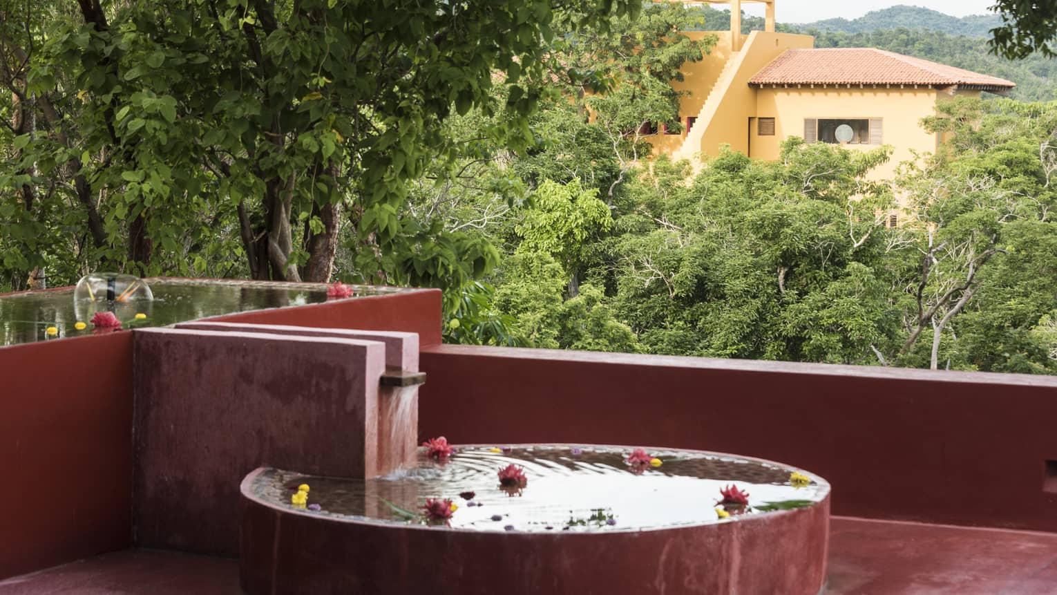 Tub with floating flowers on outdoor terrace