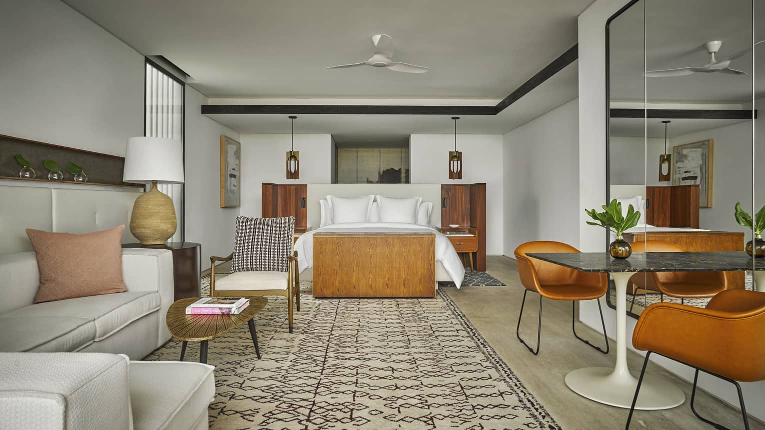 Studio-style resort suite with king bed and stylish living area at Four Seasons Resort Los Cabos