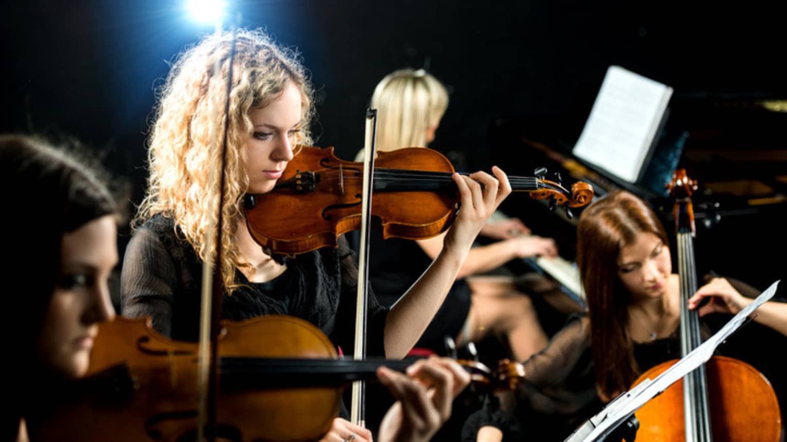 Symphony musicians play violins, cello