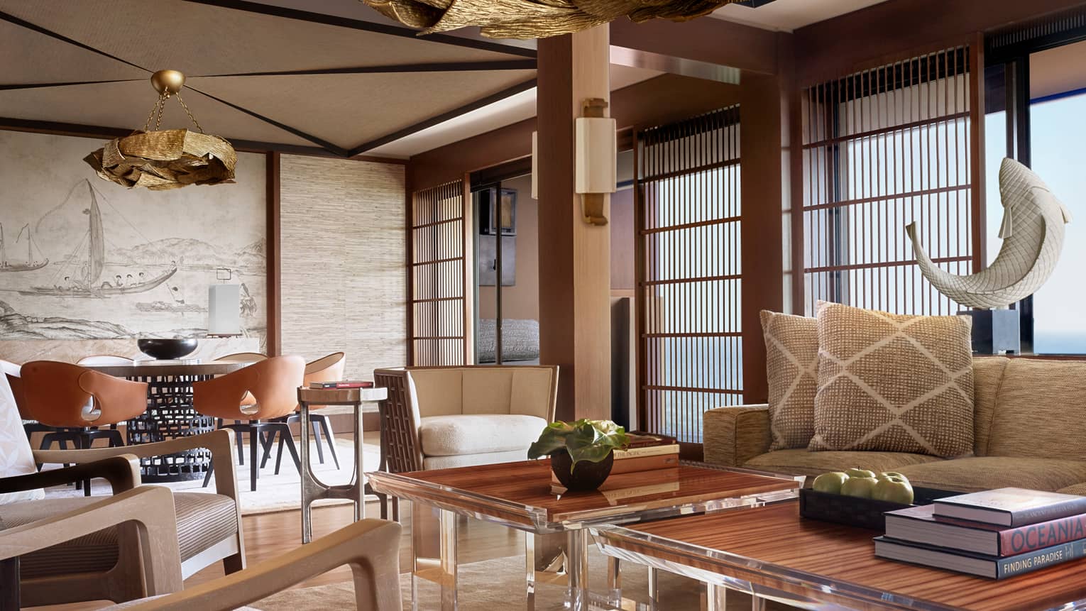 Manele Suite living room with modern furniture with wood accents, shutters, woven pillows